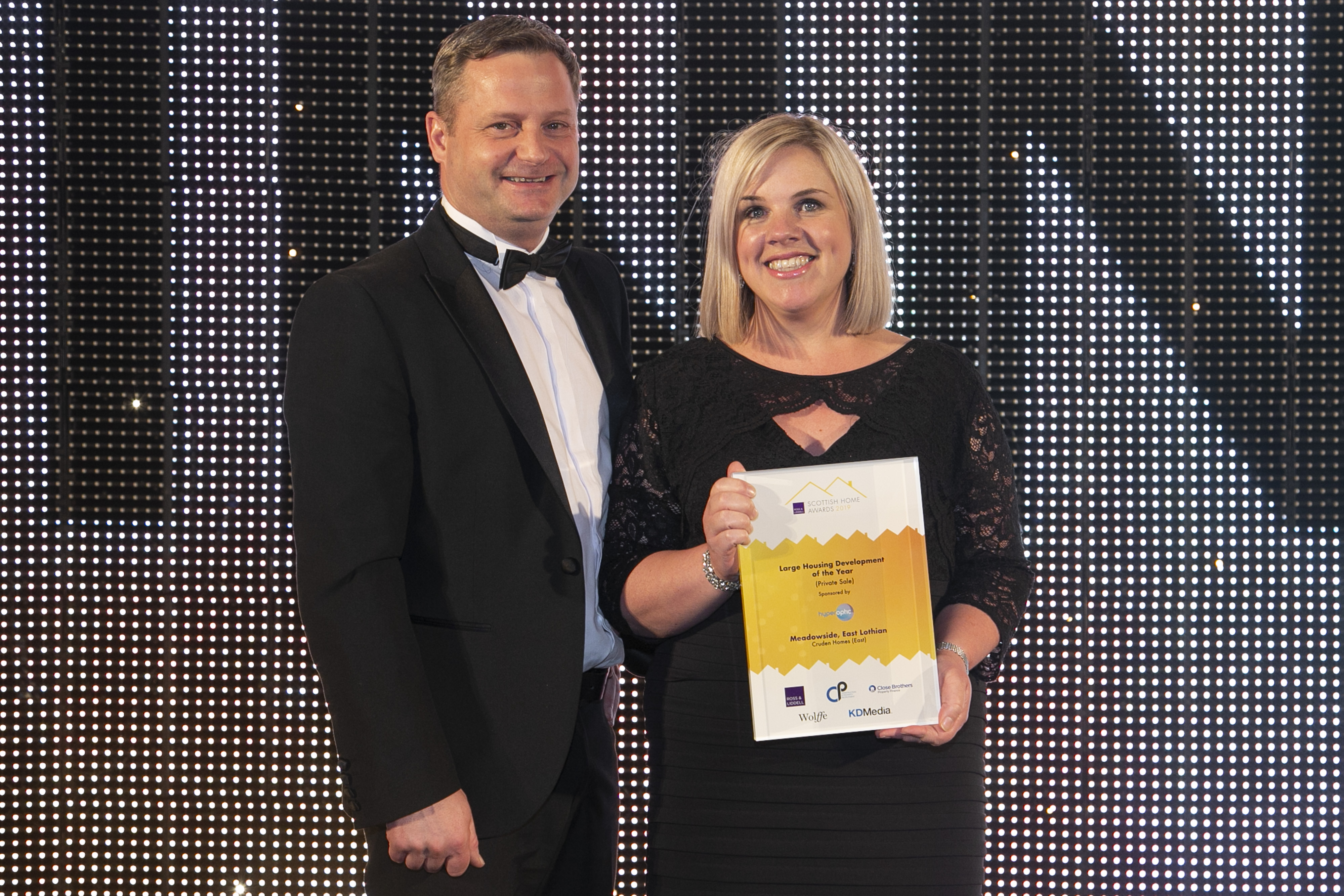 Hazel Davies sales and marketing director of Cruden Homes collecting award for Large Housing Development of the Year at Scottish Home Awards